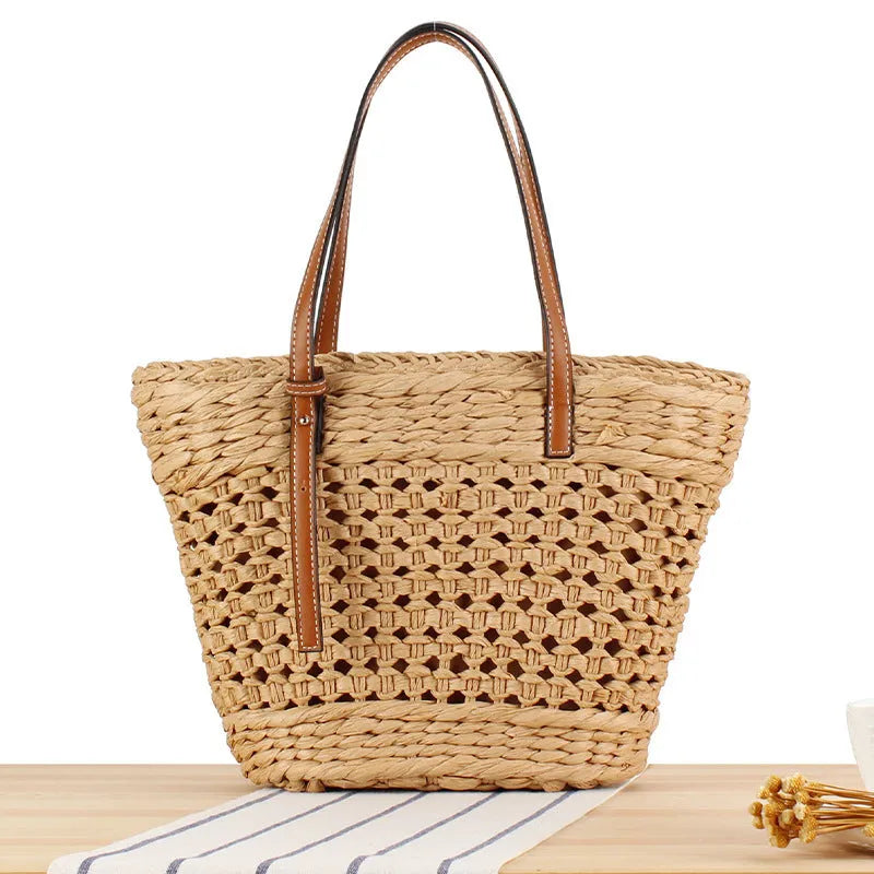 Horizontal square shoulder bag woven from paper-string with adjustable strap in beige colour