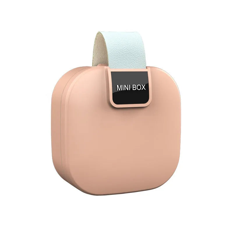 Solid colour plastic Bluetooth headset storage box with lid, 9cm by 4.5cm, in light gray.