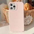 Biodegradable wheat straw mobile phone case for iPhone in seven colour options on a table.