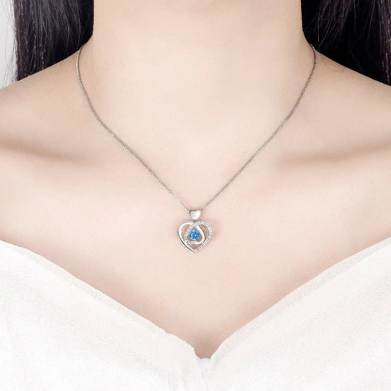 Blue diamond heart necklace and bracelet set with adjustable chain on copper background