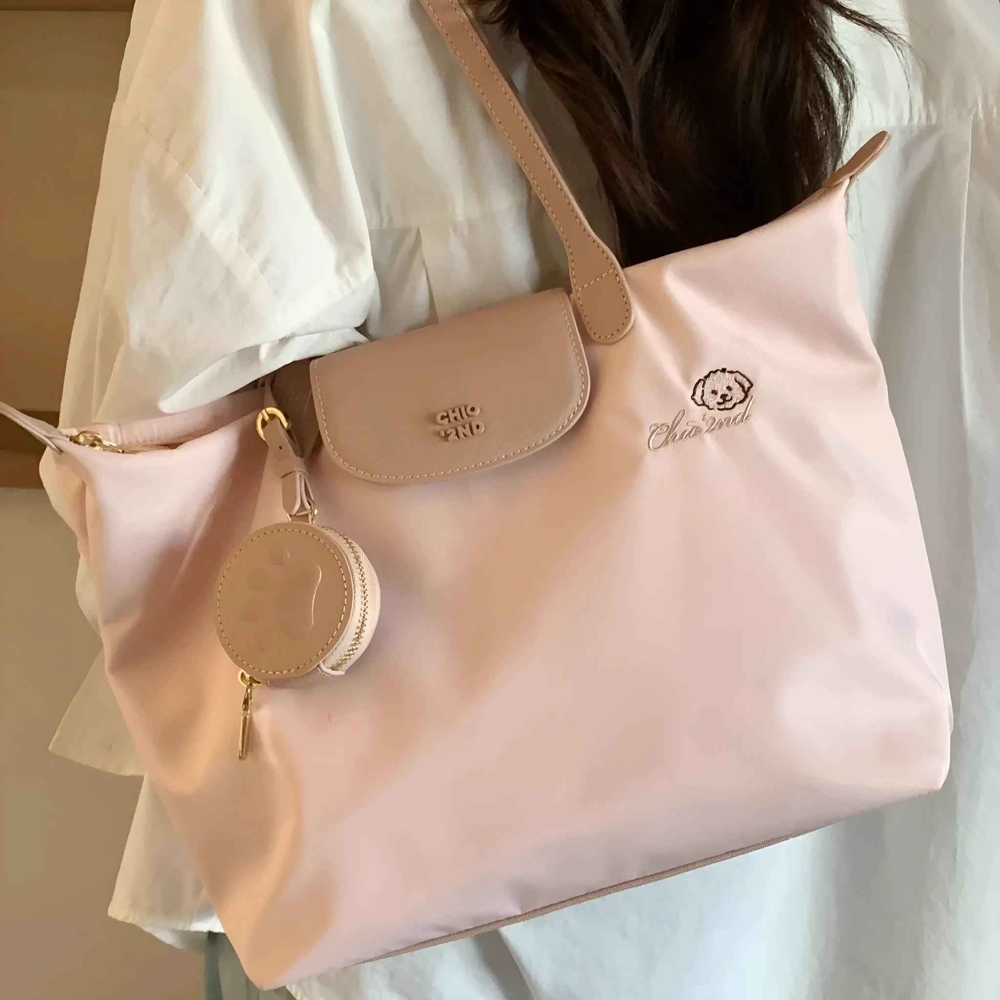 Women's pink Oxford cloth large capacity shoulder tote bag with a phone pocket.
