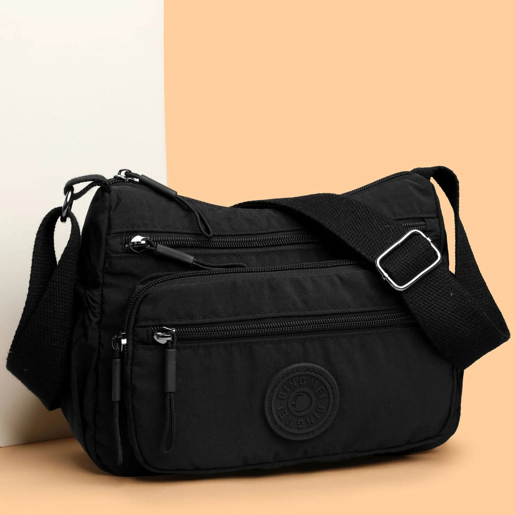Water-repellent nylon crossbody bag with three-dimensional pocket shown in grey colour