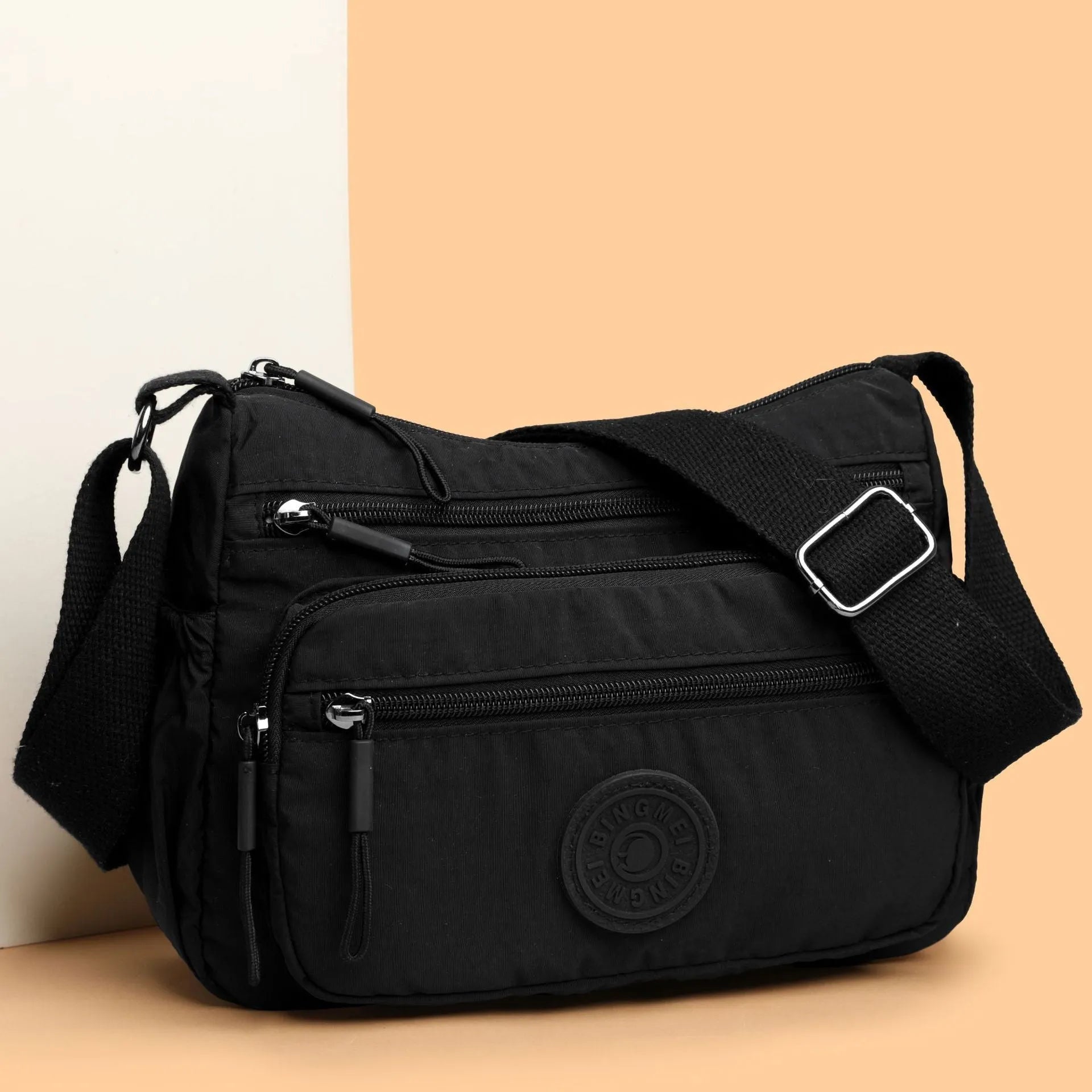 Water-repellent nylon crossbody bag with three-dimensional pocket shown in grey colour