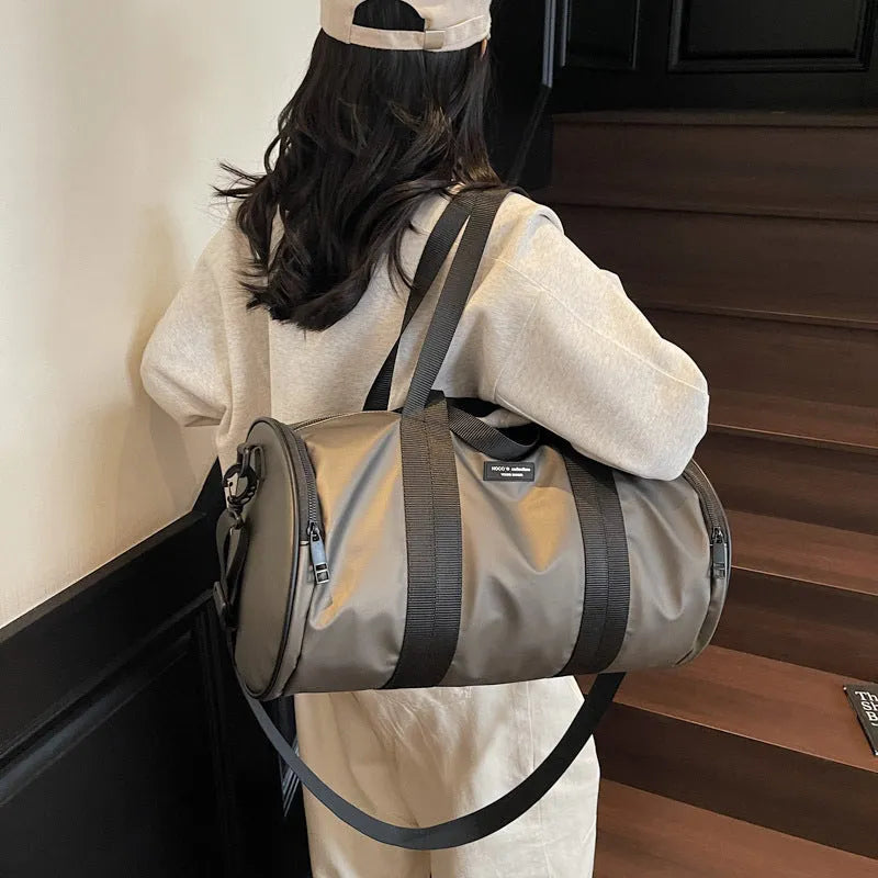 Waterproof Oxford cloth travel bag for sports and leisure in black, dark gold, and dark grey colours