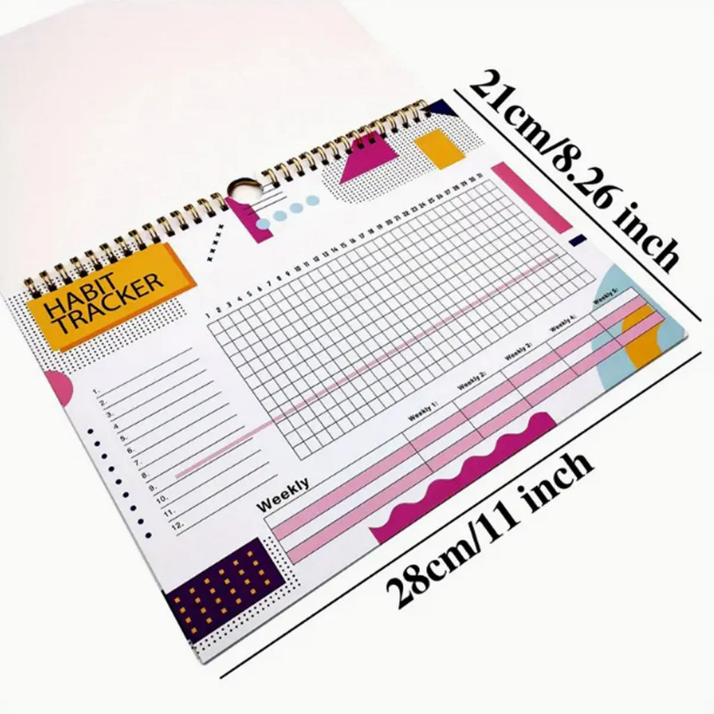 A5 habit tracking notebook open on a desk, showing internal pages, available in four colour options.