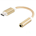 Close-up of a black woven nylon Type-C to 3.5mm female audio adapter cable.