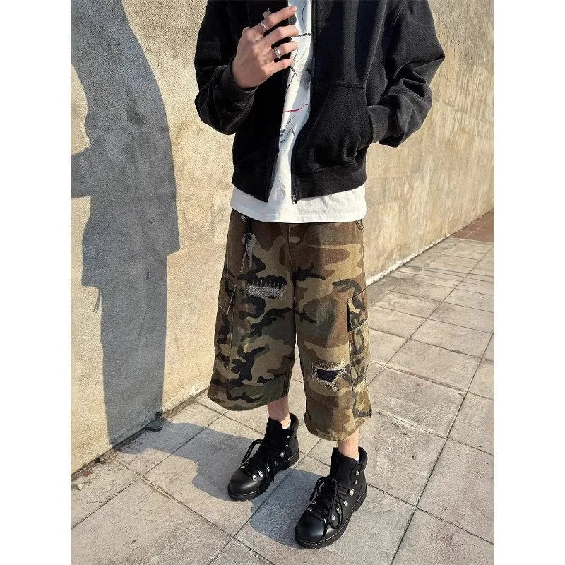 Men's loose straight-leg jeans in camouflage colour with cropped length and distressed patch detailing