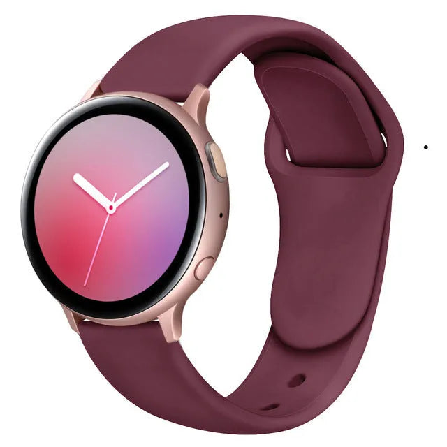 Samsung Galaxy Active 2 watch with a purple reverse buckle silicone strap on a wrist.