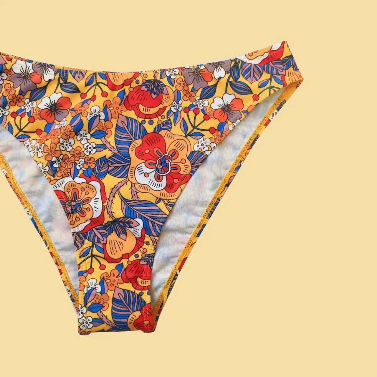 Plus size floral print strap women's bikini swimsuit with briefs style on a hanger.