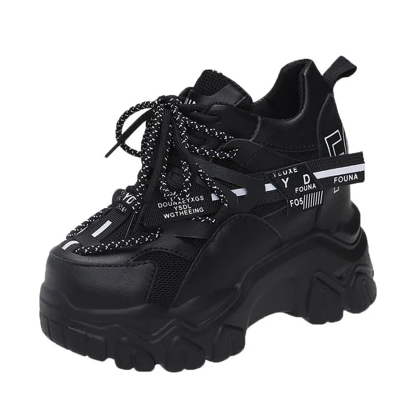 White and black women's low-top platform sports shoes with mesh upper and cross strap.
