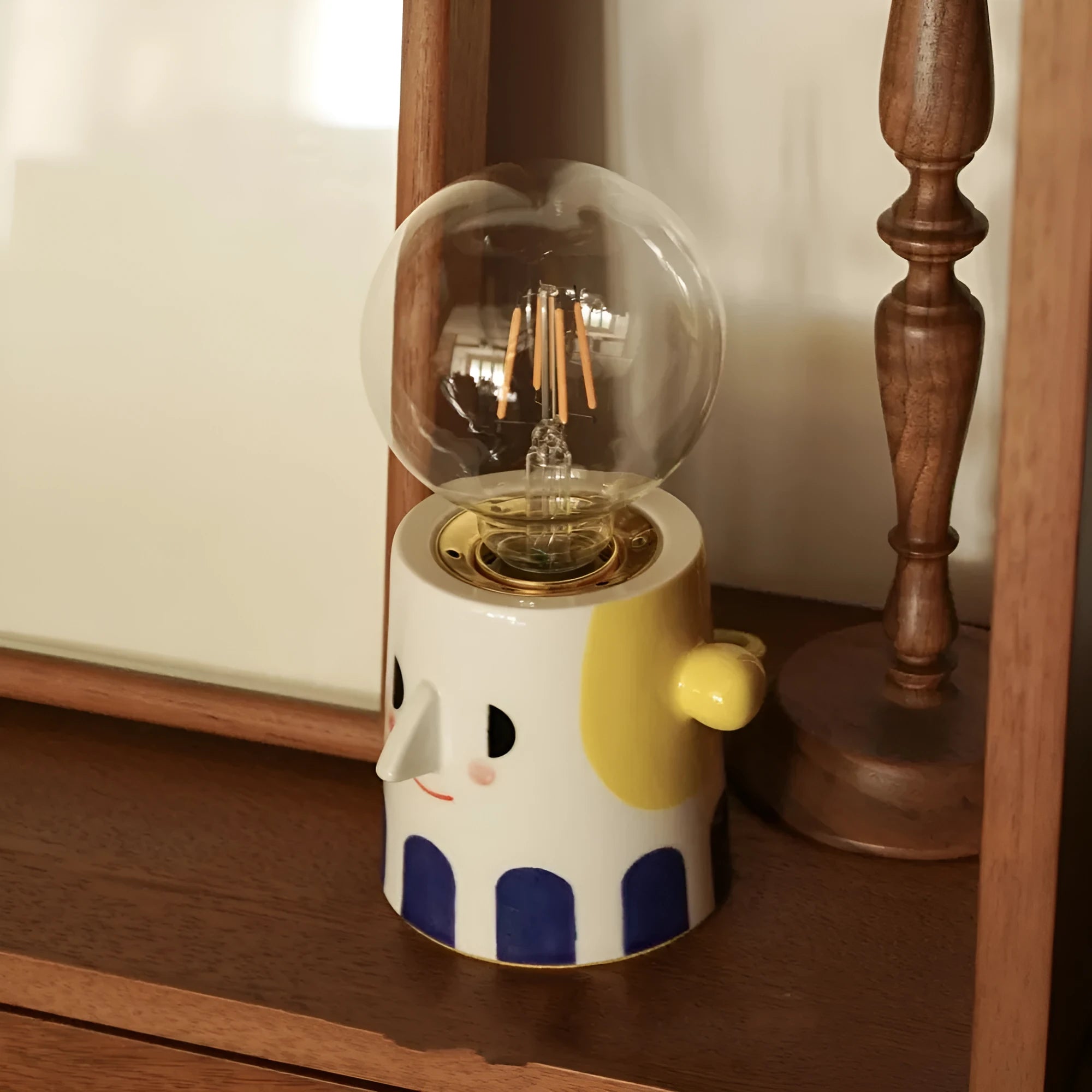 Handmade ceramic table lamp with a white spherical shade on a solid ceramic base, showcasing its simple design.