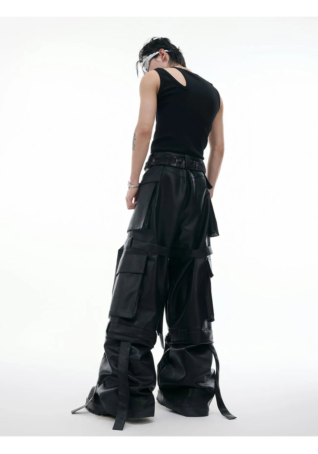 Black loose-fit trousers with a quilted pattern and multiple pockets on a mannequin.