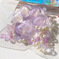 Transparent crystal coloured cat's paw squeezing toy made of soft TPR material
