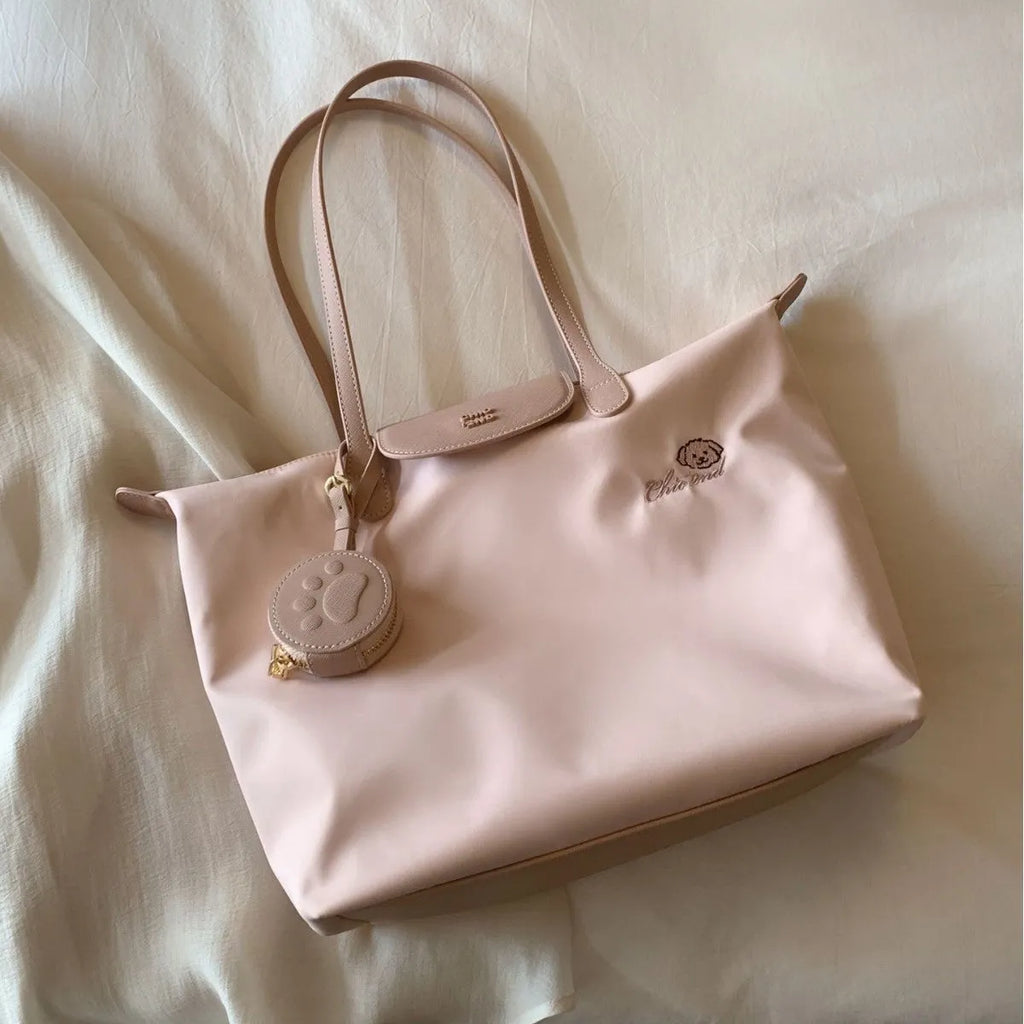 Women's pink Oxford cloth large capacity shoulder tote bag with a phone pocket.