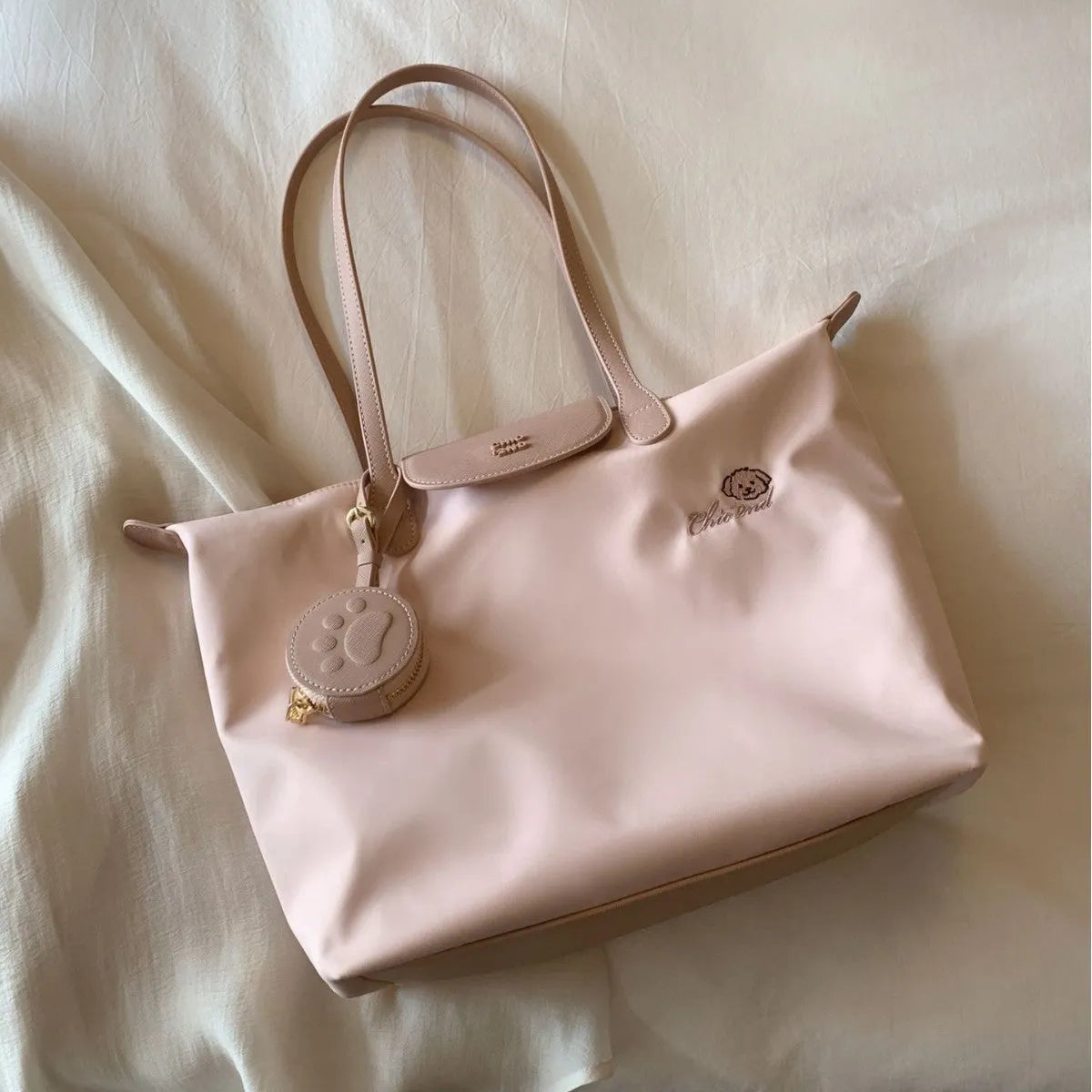 Women's pink Oxford cloth large capacity shoulder tote bag with a phone pocket.
