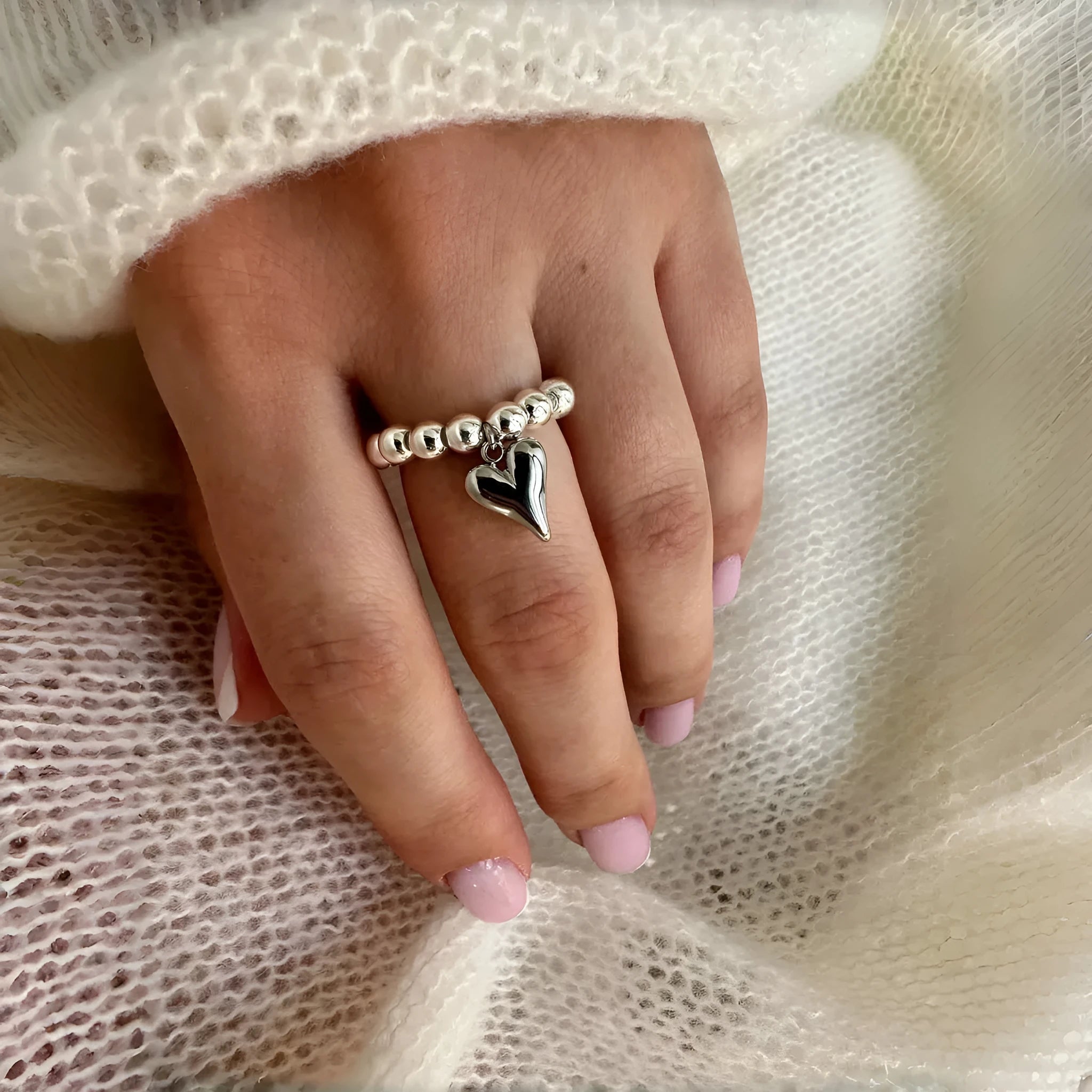 Handmade beaded elastic string love ring with geometric heart design in electroplated colours