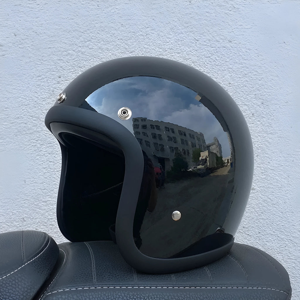 Retro-style open-face motorcycle helmet in cement grey with a textured finish and quick-release chin strap.