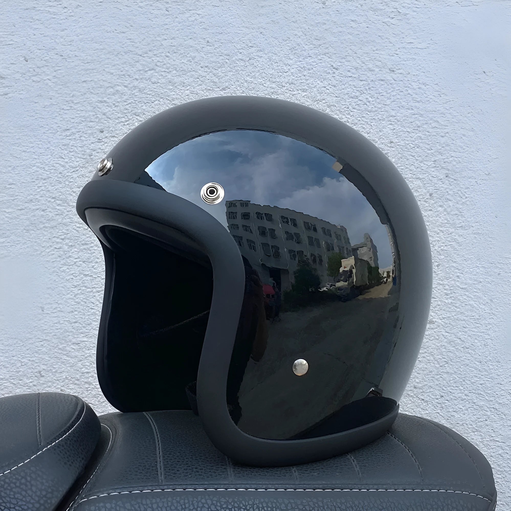 Retro-style open-face motorcycle helmet in cement grey with a textured finish and quick-release chin strap.