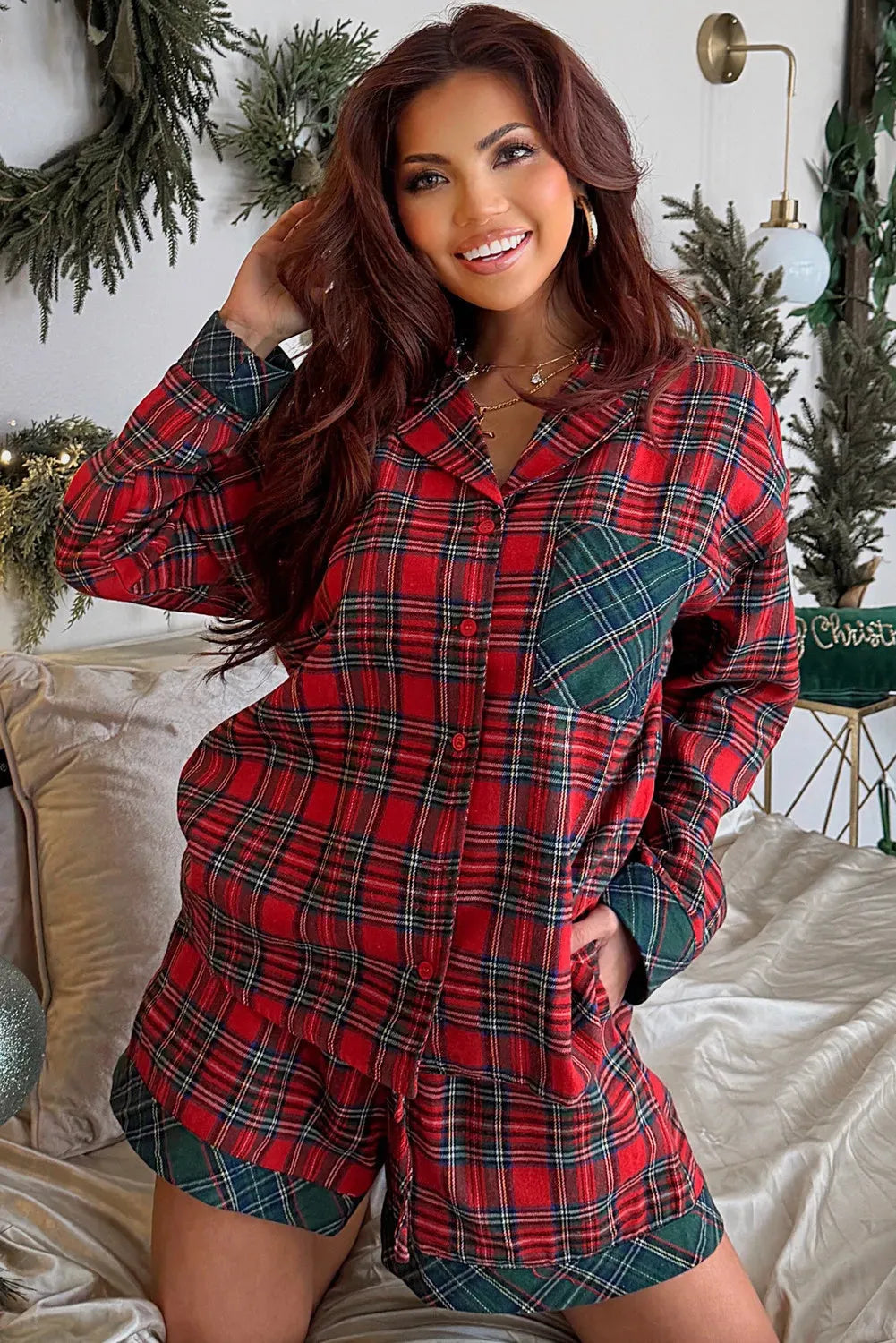 Red plaid Christmas pyjama set with contrast patch on shirt and matching shorts, laid flat.