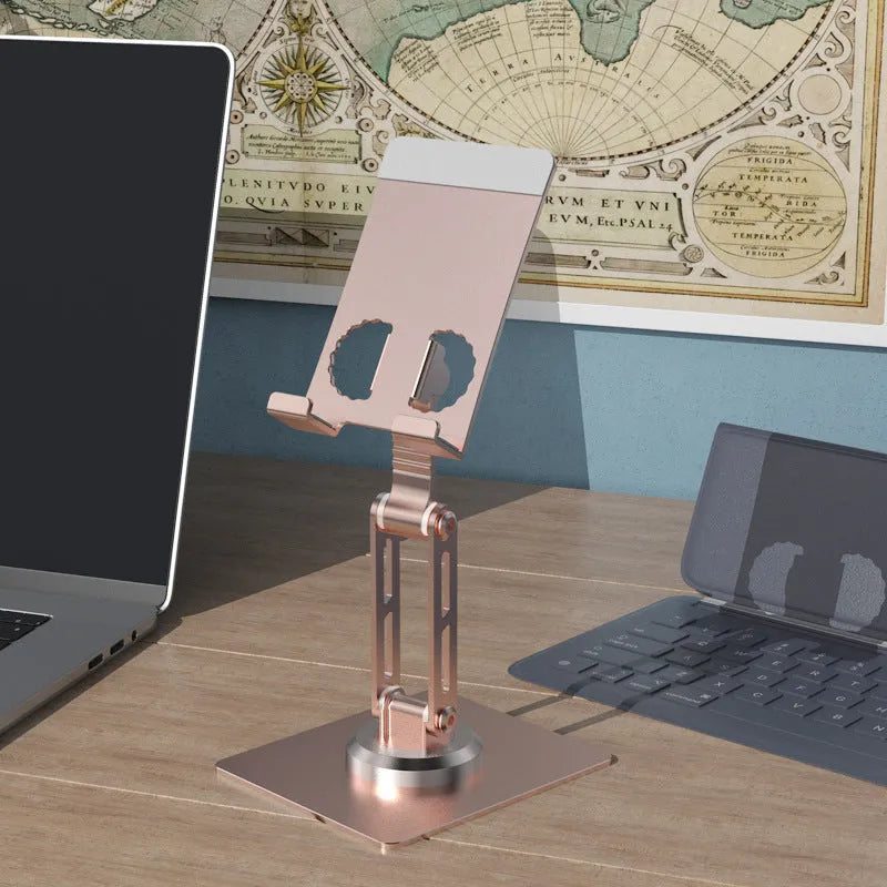 Aluminium alloy rotating mobile phone bracket in silver on a desk, showing three-axis joint and metal texture finish