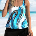 Blue tie-dye women's swimsuit with white floral split pattern, featuring a bikini top and briefs-style shorts.