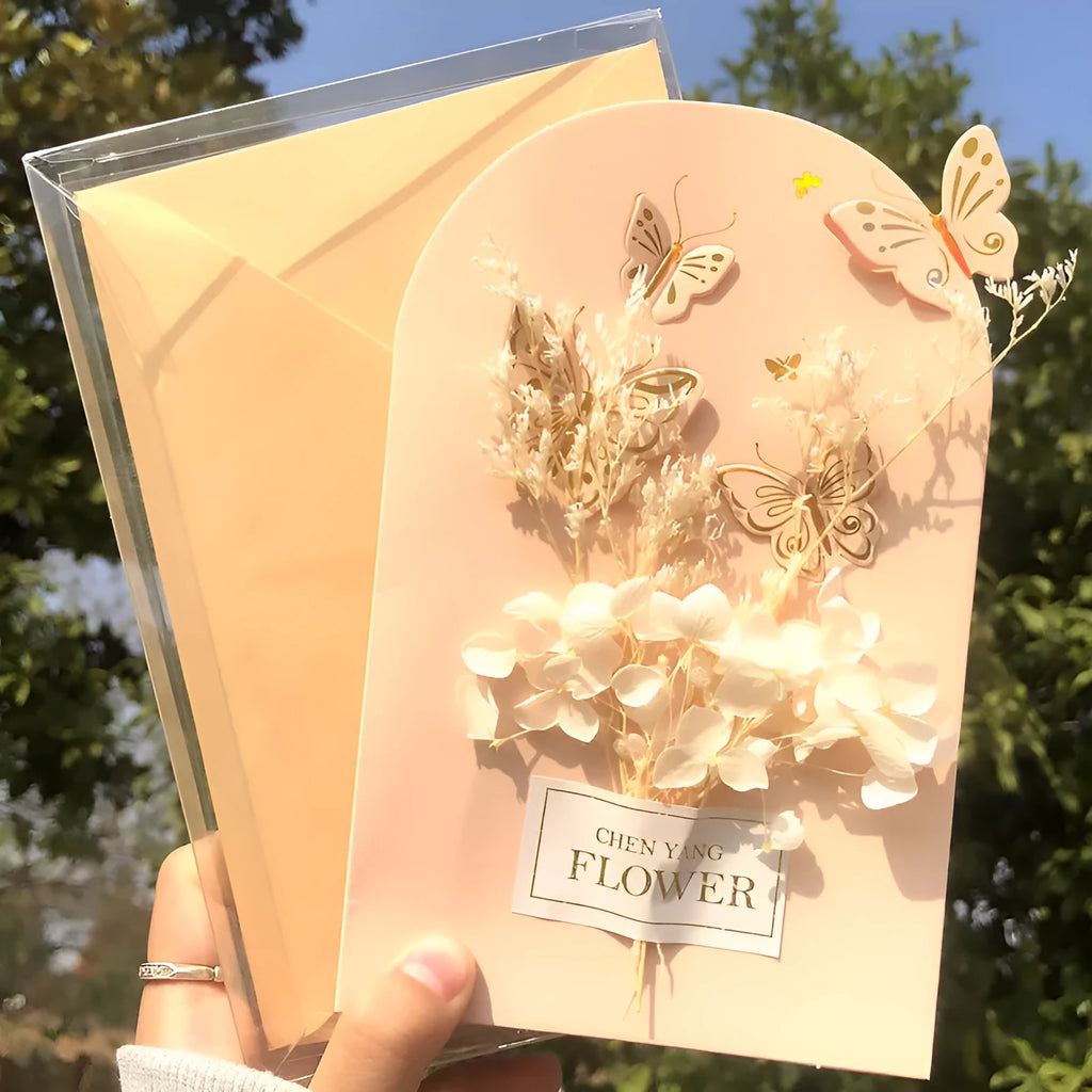 Handmade 3D butterfly birthday greeting card with artificial flowers, shown with its envelope.