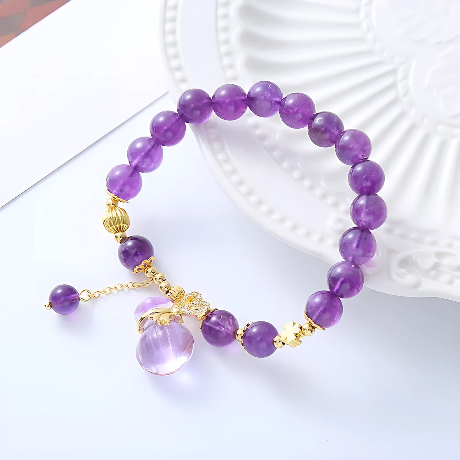 Purple amethyst crystal bracelet with money bag pendant and geometric peace buckle on wrist