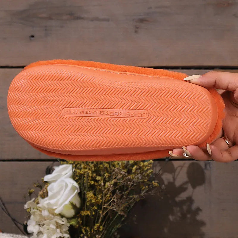 Orange coral velvet plush slippers with a non-slip PVC sole and fluffy lining.