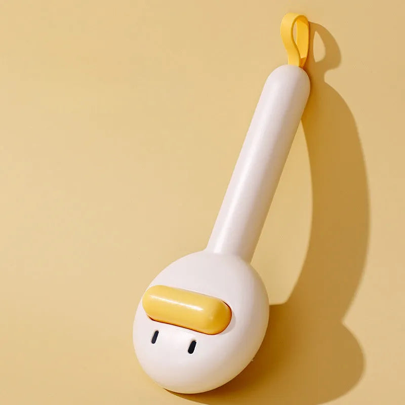 Small yellow duck-shaped pet comb for cat and dog grooming with open-section needle design