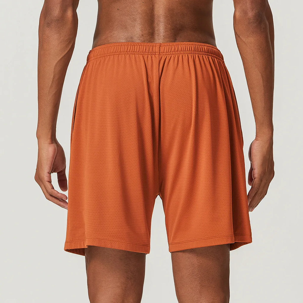 Men's quick-drying double-layer running shorts in brick red colour on a mid waist fit model.