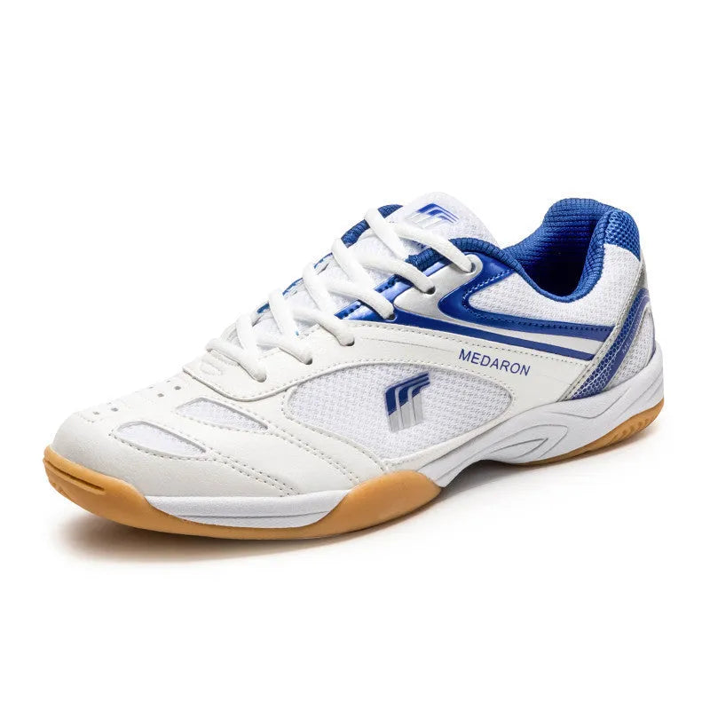 White table tennis sneakers with red trim, showing round toe and lace-up front.