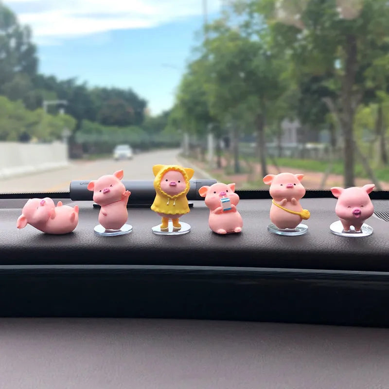 Six little pink resin pigs with colourful balloons on a rectangular anti-skid pad, cartoon car decoration