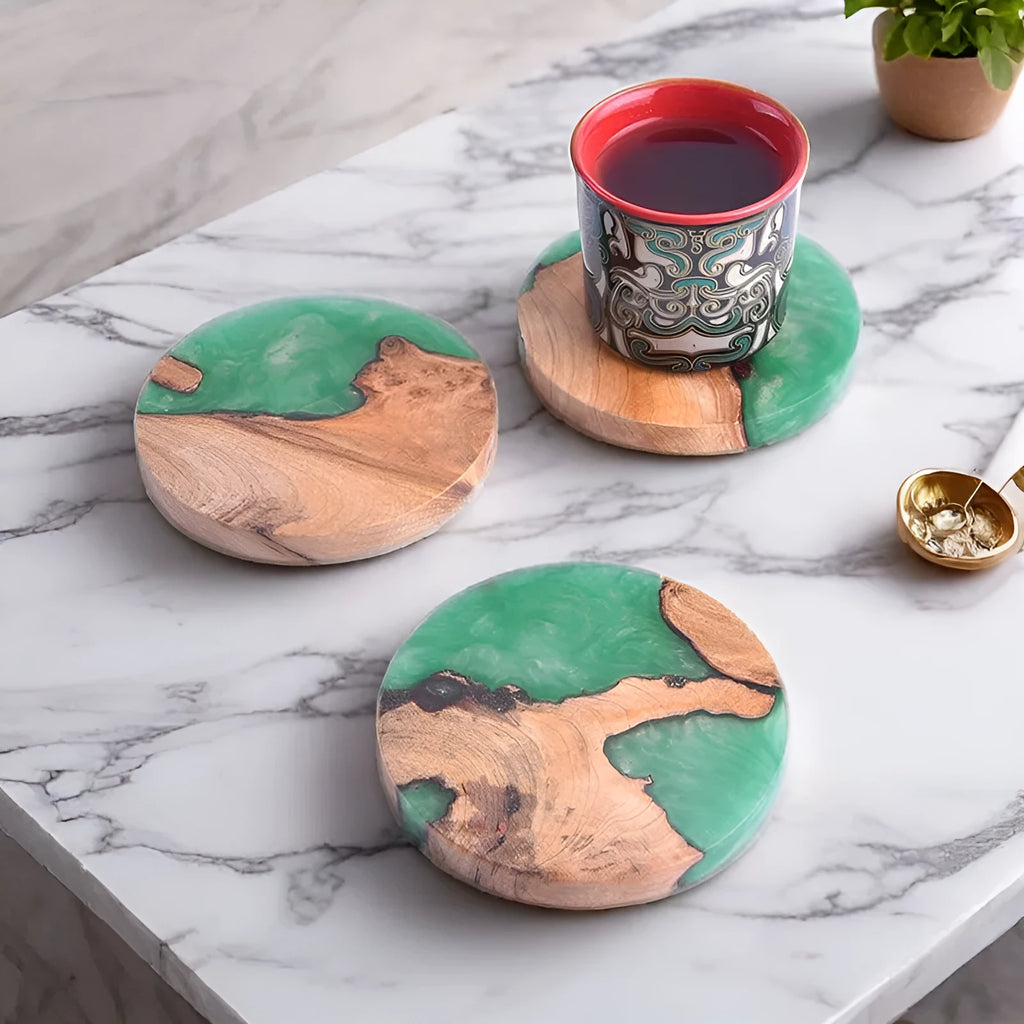 Solid colour resin coaster on a wooden table next to a mug, showing round tumour green and black options.