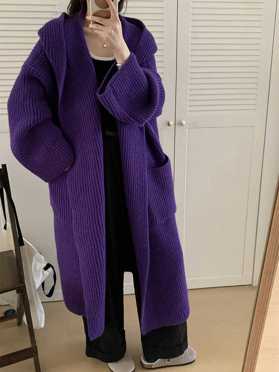 Loose-fitting beige hooded cardigan coat for women with raglan sleeves on a hanger.