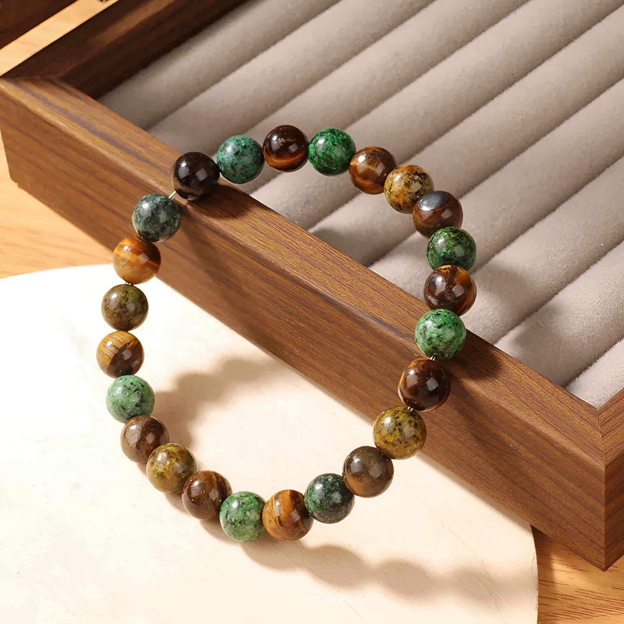 Tiger eye stone bracelet showing antique flower design with natural stone beads