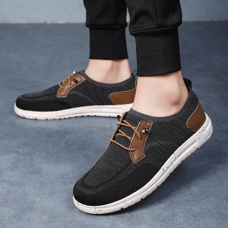 Men's black laceless canvas slip-on casual shoes with a round toe and rubber sole.
