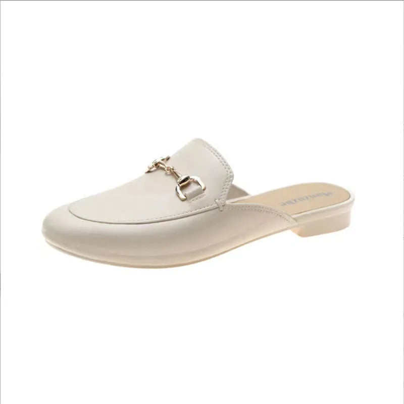 Women's PVC closed toe half slipper in white with a double buckle, shown on a foot.