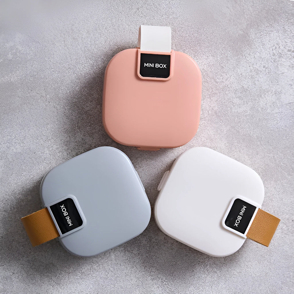Solid colour plastic Bluetooth headset storage box with lid, 9cm by 4.5cm, in light gray.