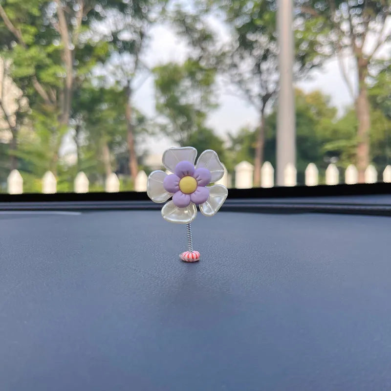 Small blue plastic swing ornament for car rear-view mirror, approx. 5cm tall.