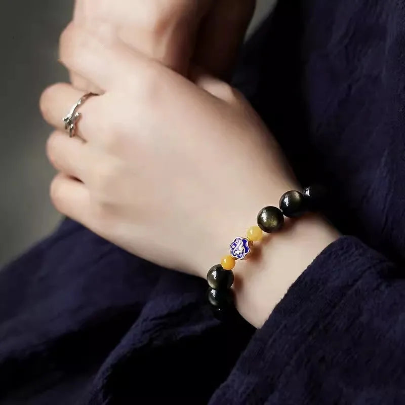 Golden obsidian ethnic bracelet with zodiac symbols on geometric 10mm stones