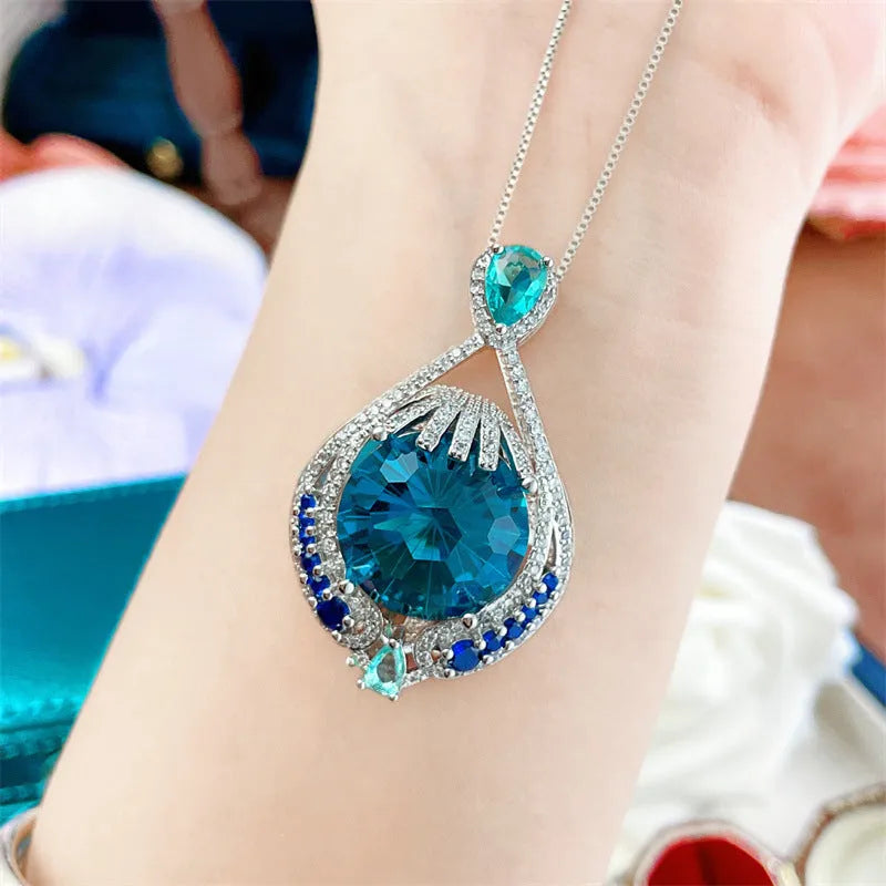 Women's geometric necklace with fireworks-cut blue gem pendant on water wave chain