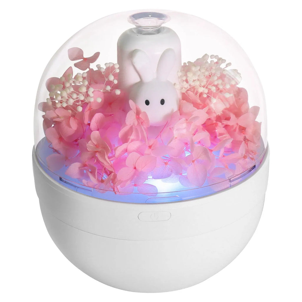 Pink ceramic rabbit vase with preserved flowers, functioning as an ultrasonic aromatherapy humidifier.