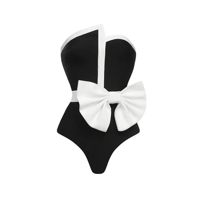 Women's black and white colour-block one-piece swimsuit with asymmetrical bow detail and tube top design