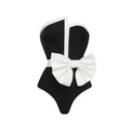 Women's black and white colour-block one-piece swimsuit with asymmetrical bow detail and tube top design