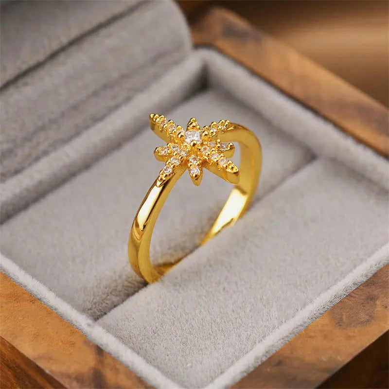 Gold electroplated women's open ring with a geometric cuff design on a copper base.