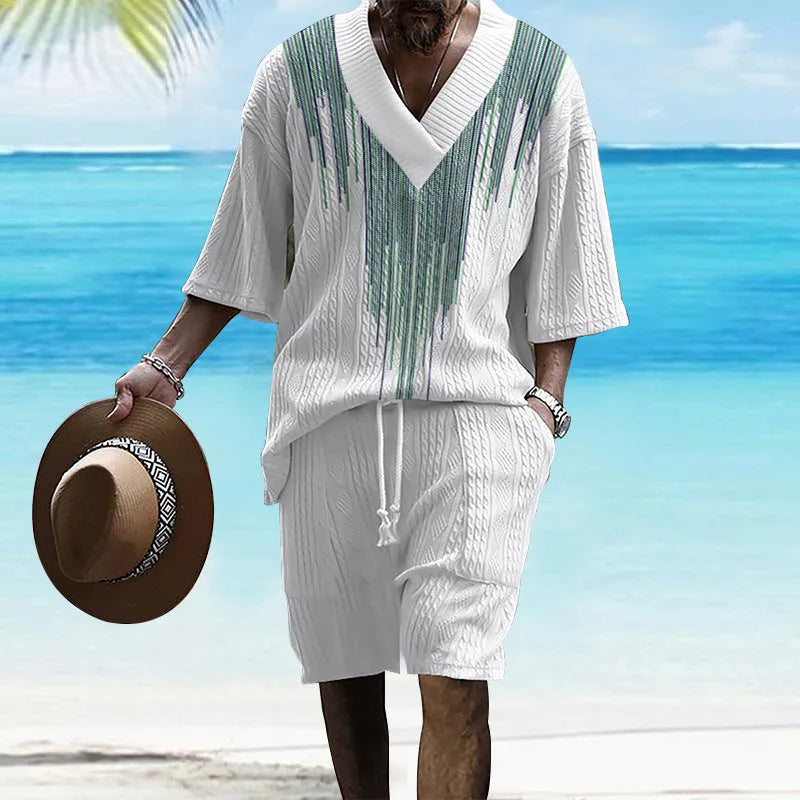 Man modelling a printed drop-shoulder knitted short-sleeved top with matching shorts in a casual setting.