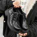Black platform warped head leather shoes with a low top microfiber upper and rubber sole.