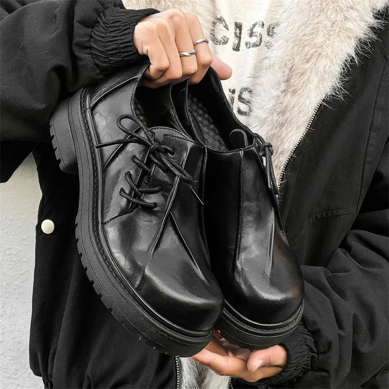 Black platform warped head leather shoes with a low top microfiber upper and rubber sole.
