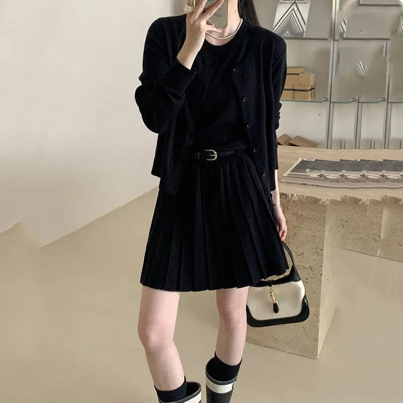 Women's grey knitted vest skirt and long-sleeve cardigan set with 3D pattern and an adjustable waist belt.