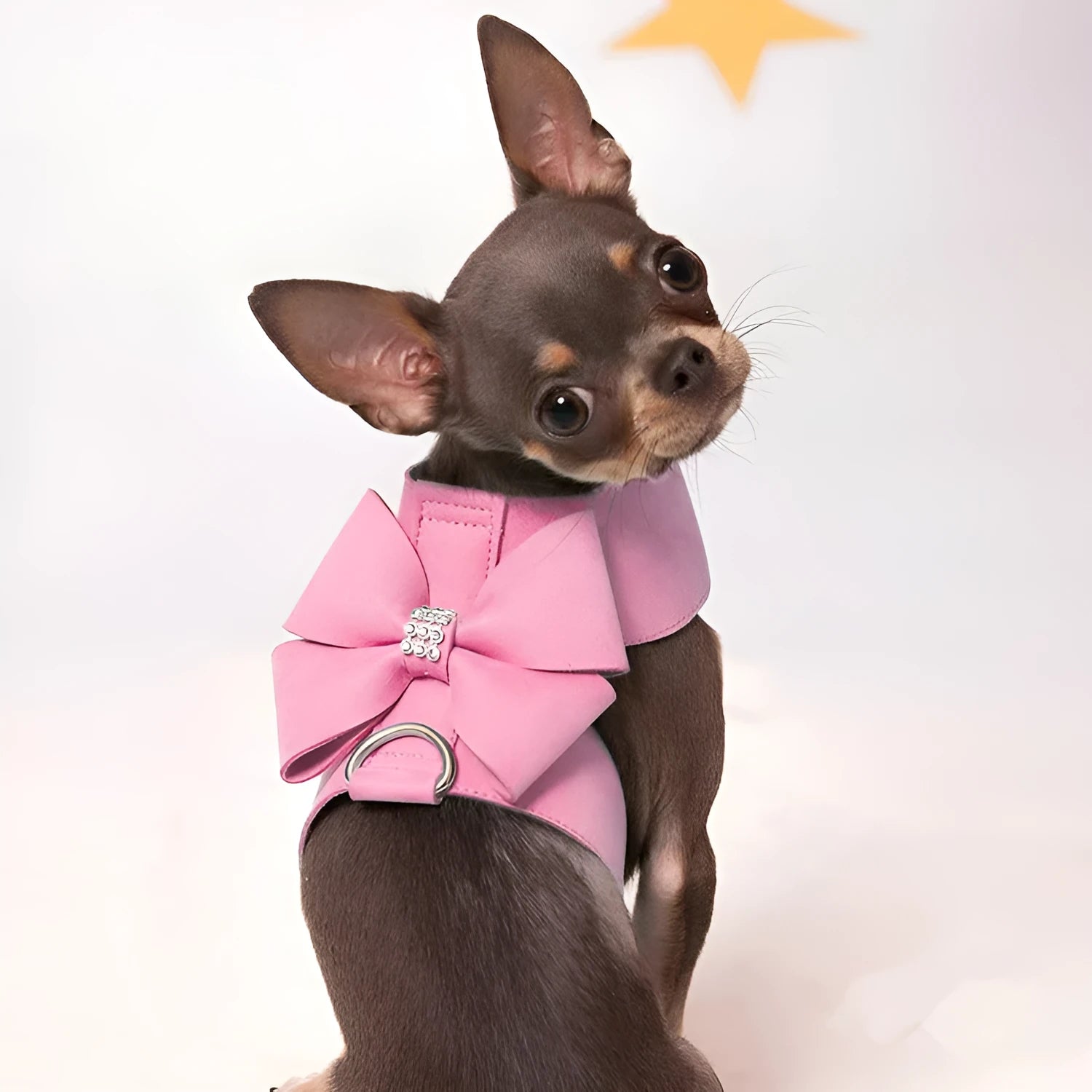 Pink microfiber puppy chest strap with a bowknot, showing the D-ring leash clip.